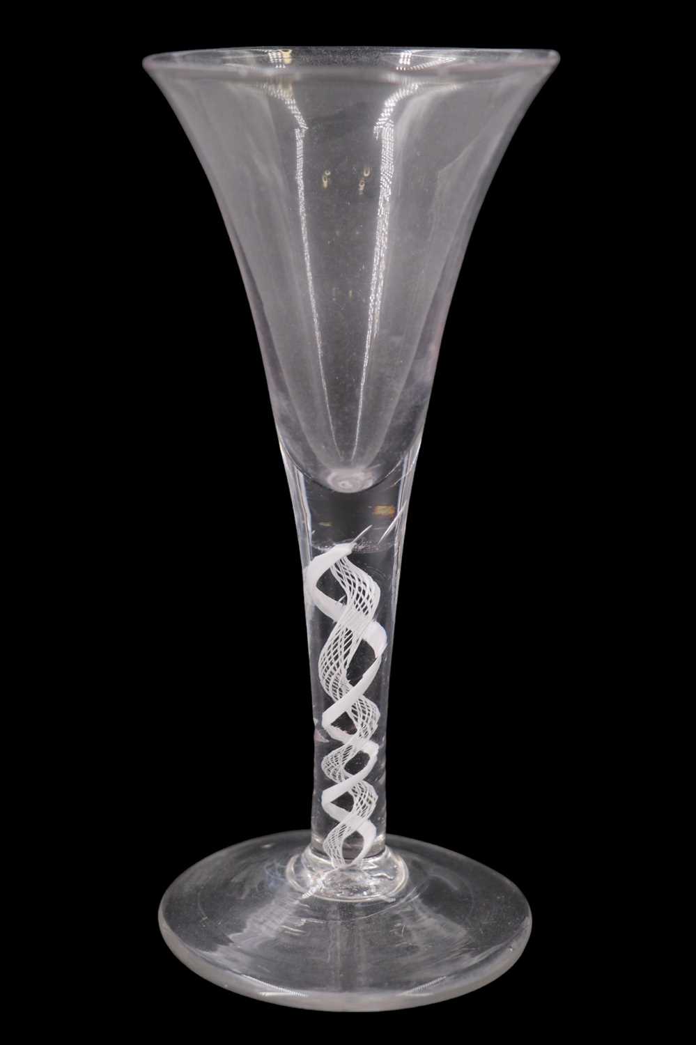 Lot 1387 - A mid 18th Century opaque twist wine glass, of...