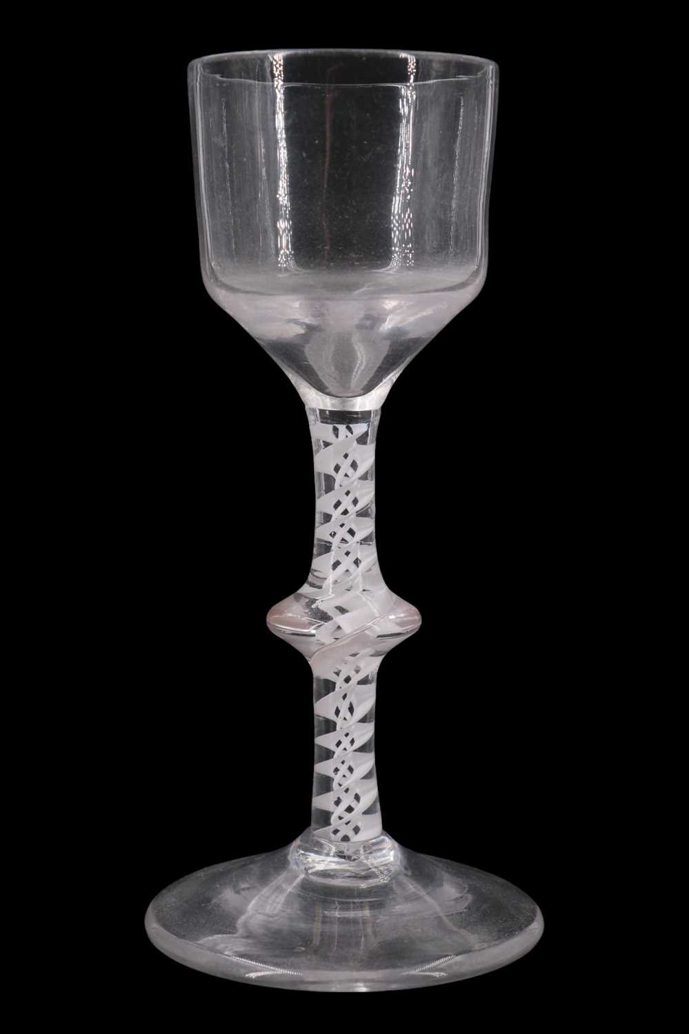 Lot 1391 - A mid 18th Century opaque twist wine glass,...