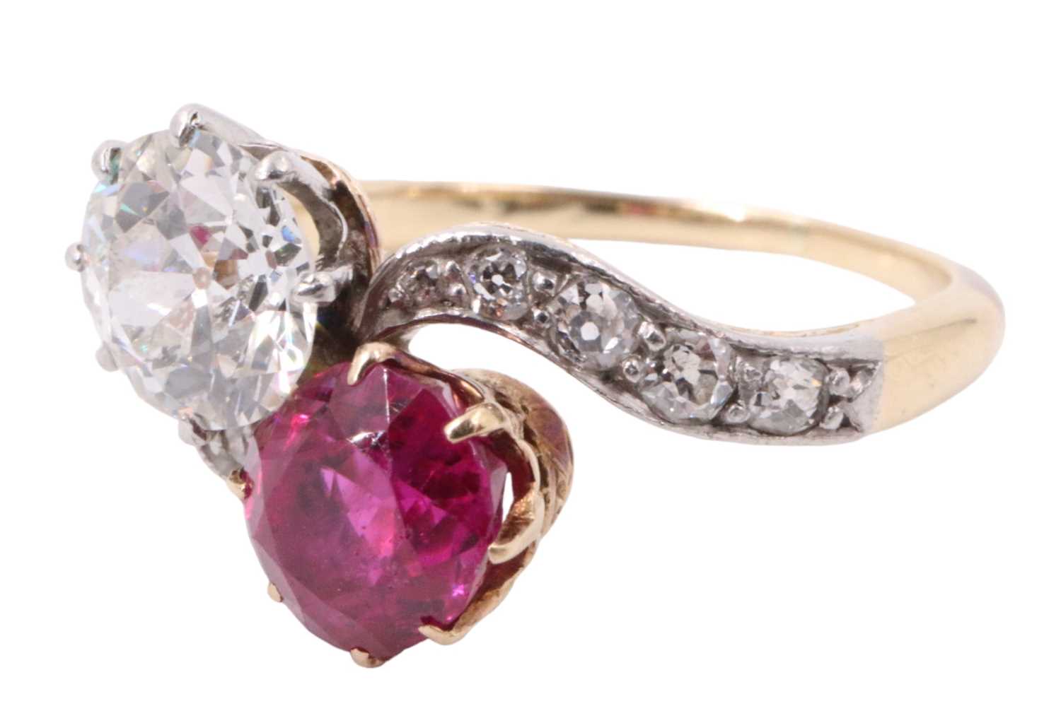 Lot 1083 - A diamond and ruby crossover ring, comprising...