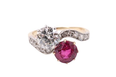 Lot 1083 - A diamond and ruby crossover ring, comprising...