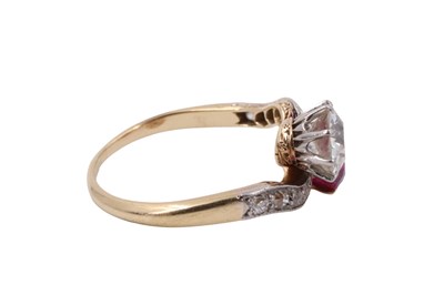 Lot 1083 - A diamond and ruby crossover ring, comprising...