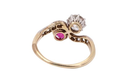 Lot 1083 - A diamond and ruby crossover ring, comprising...