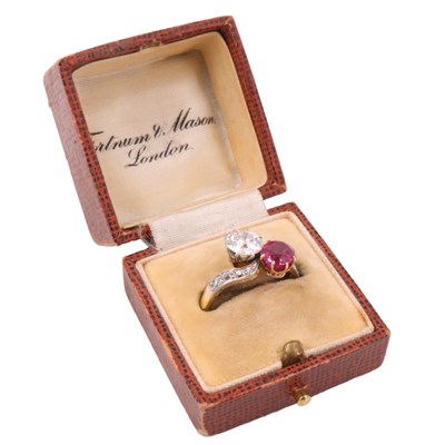 Lot 1083 - A diamond and ruby crossover ring, comprising...