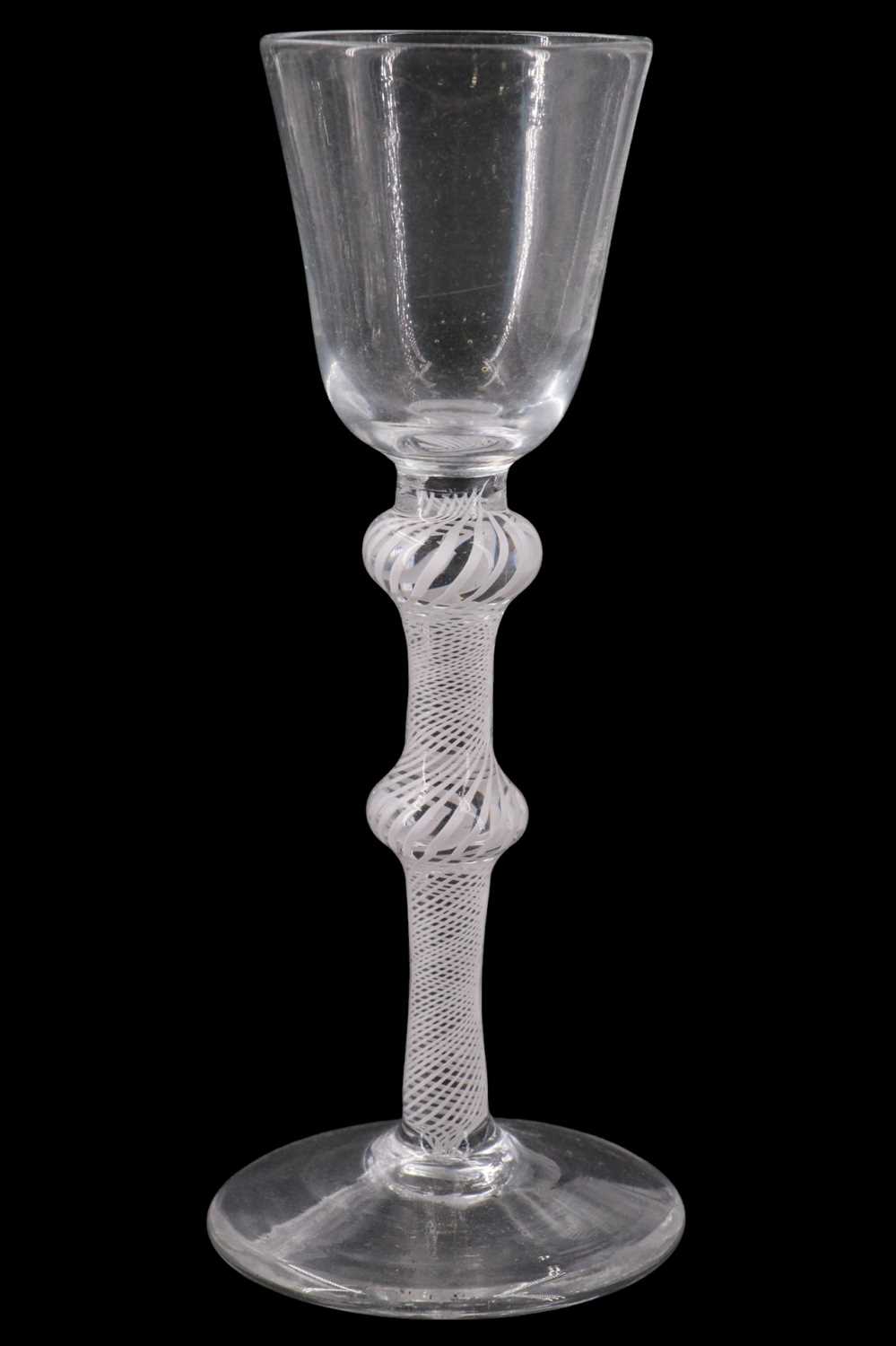 Lot 1377 - A George III opaque twist wine glass, having a...