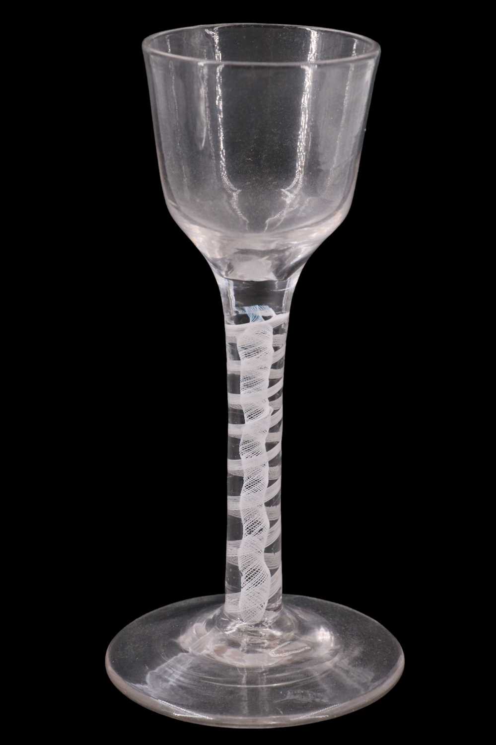 Lot 1379 - A mid 18th Century opaque twist wine glass,...