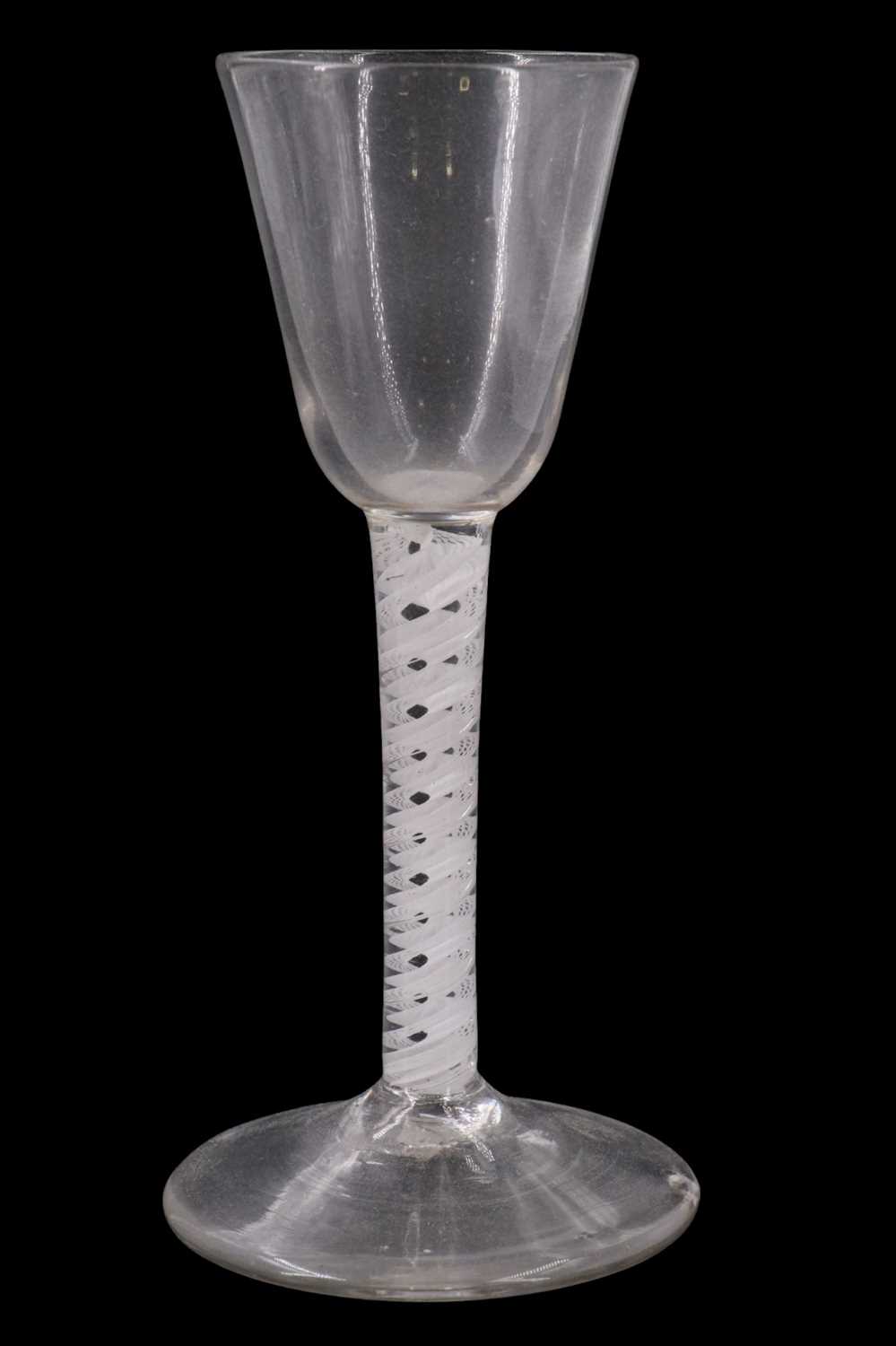 Lot 1373 - A mid 18th Century opaque twist wine glass,...