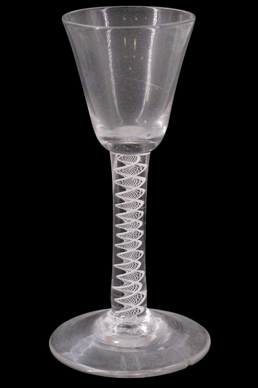 Lot 1374 - A mid 18th Century opaque twist wine glass,...