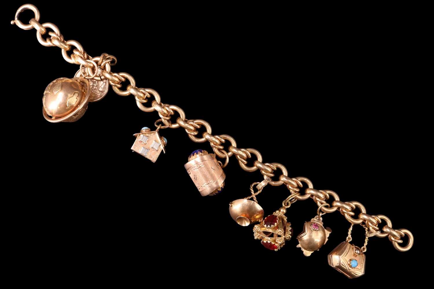 Lot 1014 - A 1960s high carat yellow metal charm bracelet,...