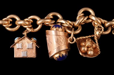 Lot 1014 - A 1960s high carat yellow metal charm bracelet,...