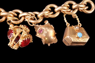 Lot 1014 - A 1960s high carat yellow metal charm bracelet,...
