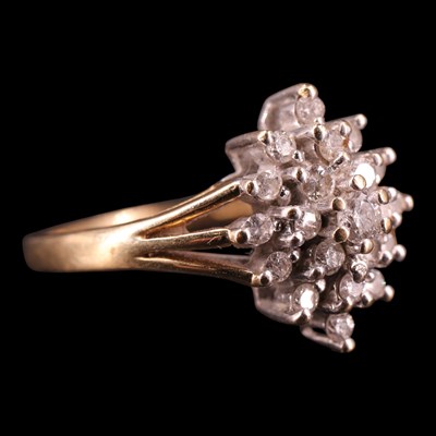Lot 1255 - A late 1980s diamond cluster ring, comprising...