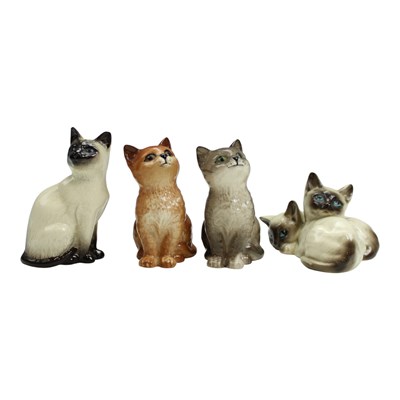 Lot 1124 - Four Royal Doulton cats, 10 cm