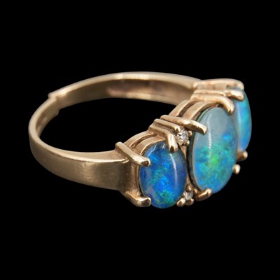 Lot 1292 - An early 1990s diamond and opal triplet ring,...