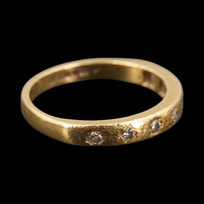 Lot 1298 - A late 1970s diamond-set band, comprising...
