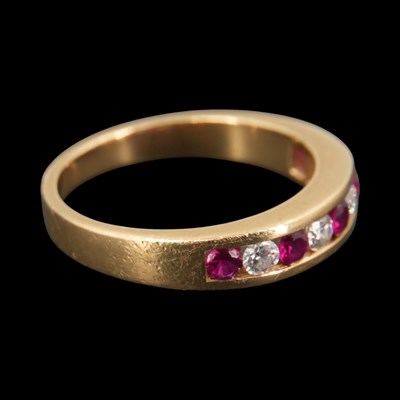 Lot 1299 - A contemporary diamond and ruby half-hoop...
