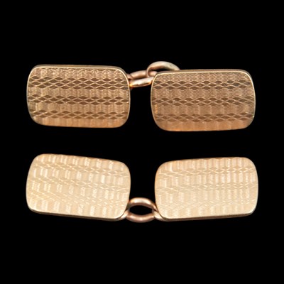 Lot 1274 - A pair of engine-turned 9 ct gold cufflinks, 7....