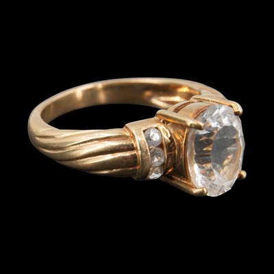 Lot 1310 - A contemporary white topaz finger ring,...