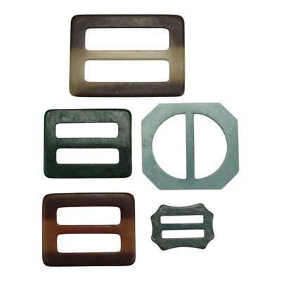 Lot 928 - Five vintage 1960s composition belt buckles,...