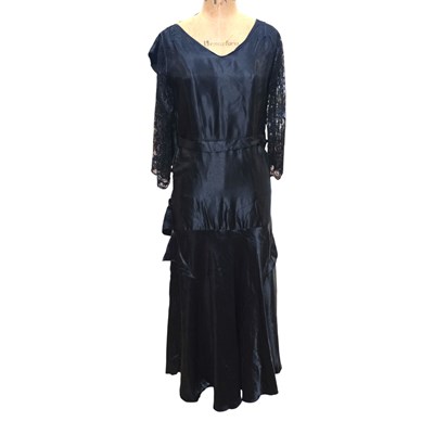 Lot 935 - An early 20th Century black silk dress having...