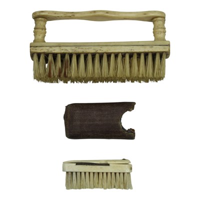 Lot 945 - A Georgian turned and carved bone nail brush,...