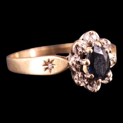 Lot 1362 - A late 1980s sapphire and diamond cluster ring,...
