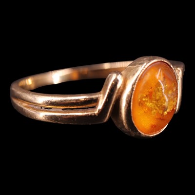 Lot 1365 - A late 1990s amber ring, comprising an oval...