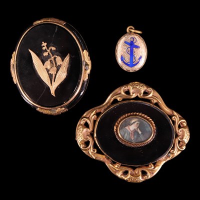 Lot 1387 - Two Victorian black enamelled brooches...