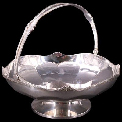 Lot 891 - A 1920s silver large swing-handled footed bowl,...