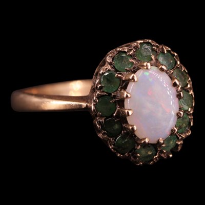 Lot 1427 - A 1970s opal, emerald and 9 ct gold oval...