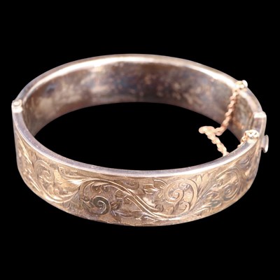 Lot 969 - A vintage white metal hinged bangle, faced  in...