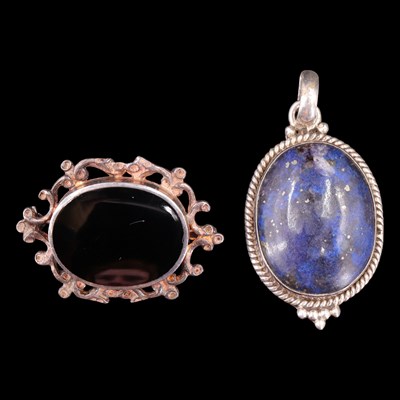 Lot 1001 - An oval lapis lazuli cabochon and white metal...