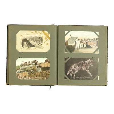 Lot 284 - An Edwardian postcard album, containing a...