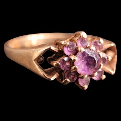 Lot 994 - A 1970s amethyst ring, comprising a flowerhead...