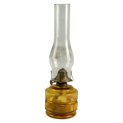 Lot 706 - A 1920s amber glass finger oil lamp, 26 cm