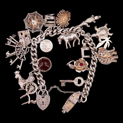 Lot 978 - A 1970s silver charm bracelet having spiderweb,...