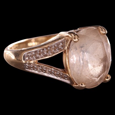 Lot 982 - A 1980s topaz and diamond cocktail ring,...