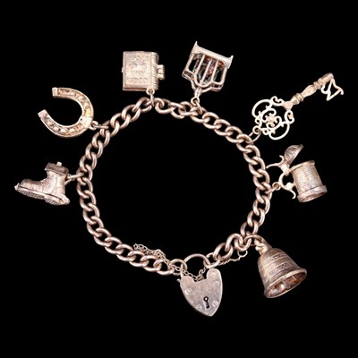Lot 1010 - A vintage white metal charm...