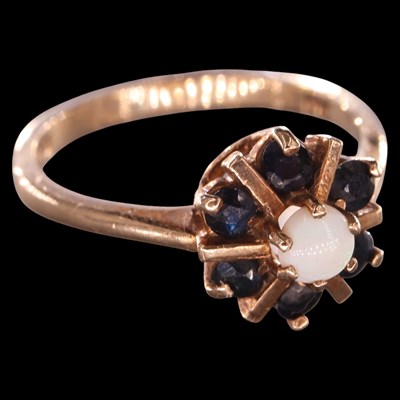 Lot 1017 - A 1970s opal and sapphire cluster ring,...