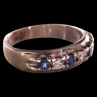 Lot 1021 - A contemporary diamond and sapphire half-hoop...