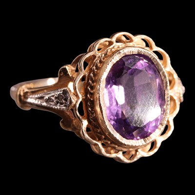 Lot 1023 - A 1980s amethyst and diamond ring, comprising...