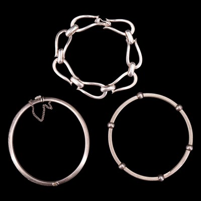 Lot 1037 - A 1950s foliate-engraved silver hinged bangle...