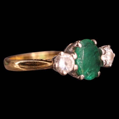 Lot 1041 - A near-contemporary three-stone emerald and...