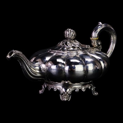 Lot 879 - A Victorian silver tea pot, of compressed...