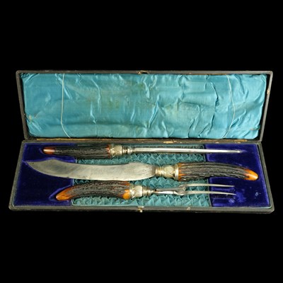 Lot 930 - A Victorian antler-handled carving set, the...