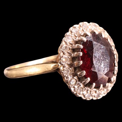 Lot 952V - A 1970s garnet and sapphire cluster ring,...