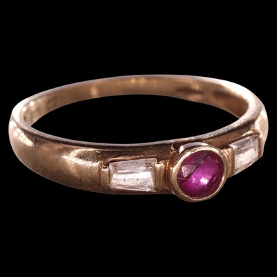 Lot 952E - A near-contemporary three-stone ruby and cubic...