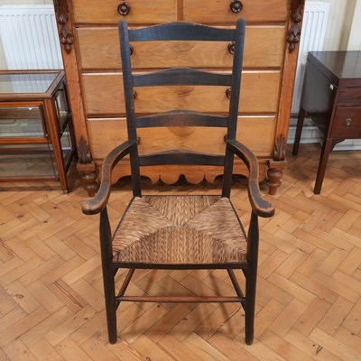 Lot 1205 - An early 20th Century rush-seated ladder-back...