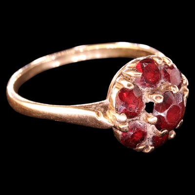 Lot 1347 - A 1960s garnet cluster ring, comprising a...