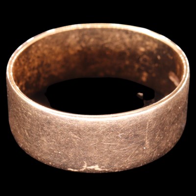 Lot 1363 - A 1980s 9 ct gold broad wedding band, R/S, 3.4 g
