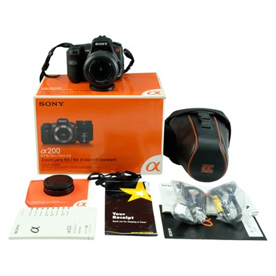 Lot 604 - A Sony Alpha A200K DSLR camera, boxed with...